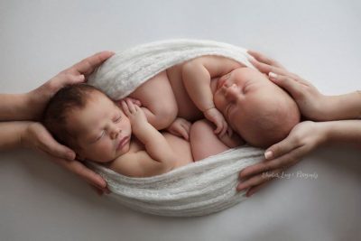 two babies are wrapped together to feel safe and secure